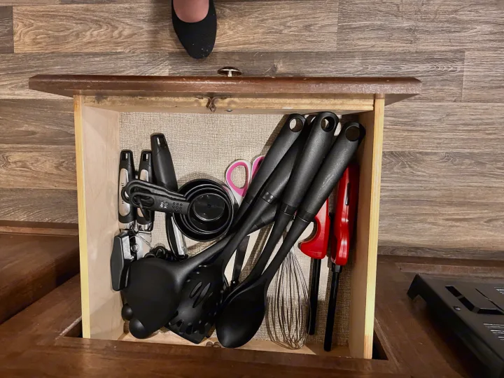 Well-stocked kitchen drawer in this rv rental, featuring essential cooking utensils and measuring cups for easy meal prep.. Keystone RV Hideout 2017