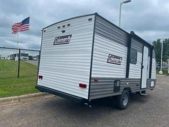 White & gray Coleman travel trailer for RV rental, featuring a compact design, side awning, and rear bumper. Ready for adventure.. Coleman lantern lt 17b 2024