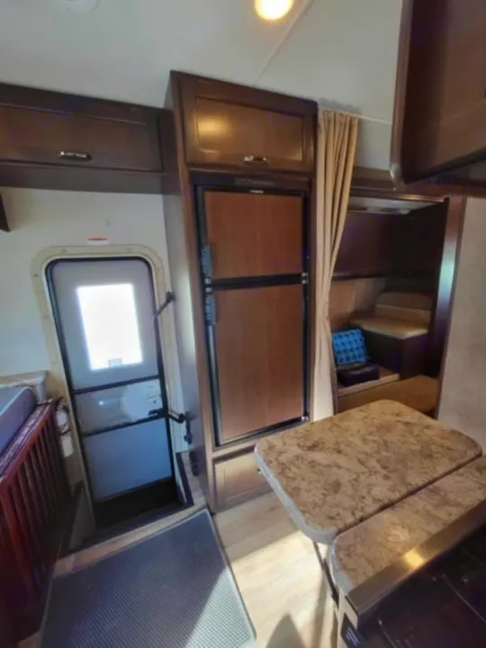 RV rental: cozy interior with fridge, entry door, cabinets, and a dinette ready for your journey.. Thor Four Winds 2020