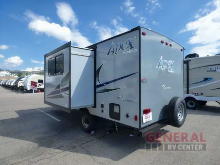 Gray Apex Nano travel trailer with an extended slide-out, ideal for RV rental adventures. Seen in an outdoor dealer lot.. Coachmen Apex Nano 2018