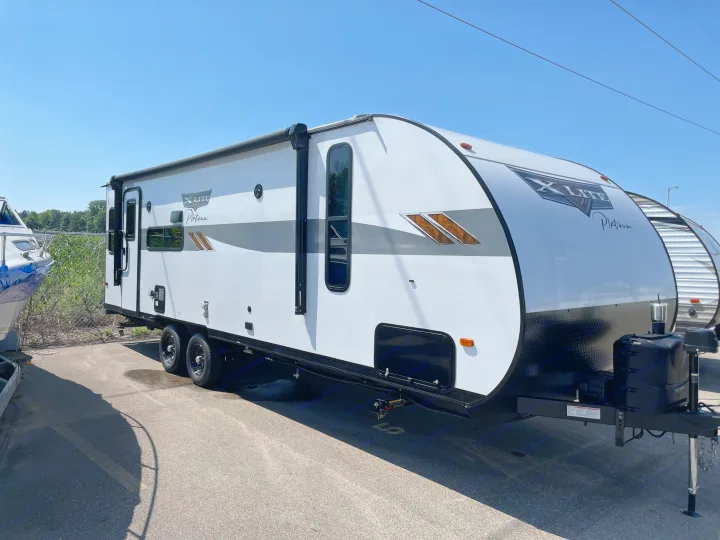 Modern white X-Lite Platinum travel trailer ready for rv rental. Perfect for your next adventure.. Forest River Wildwood X-Lite 2023
