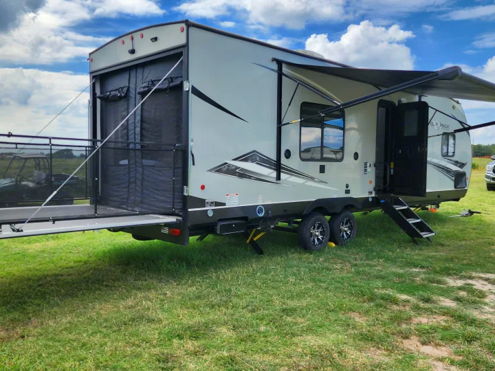 Enjoy this RV rental, a toy hauler travel trailer, with its rear patio and side awning ready for adventure.. Forest River Wolf Pack 2023