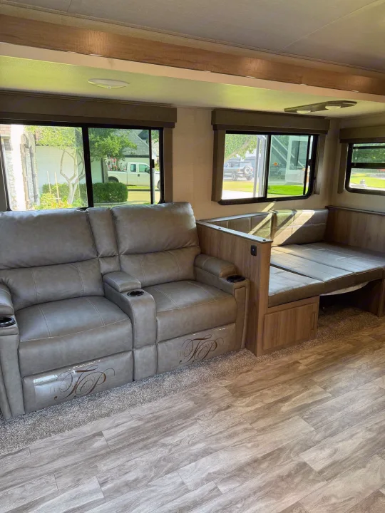 This RV rental features a comfortable living space with dual recliners, a convertible dinette, and bright windows.. Grand Design Imagine 2022