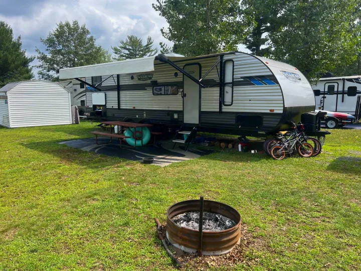 Enjoy an RV rental: a Salem Cruise Lite travel trailer at a grassy campsite with a picnic table, fire pit, and bikes.. Forest River Salem Cruise Lite 2022