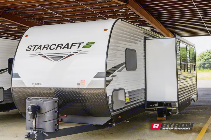Front view of a white Starcraft travel trailer RV with black accents and a slide-out, perfect for RV rental.. Starcraft Autumn Ridge 2023