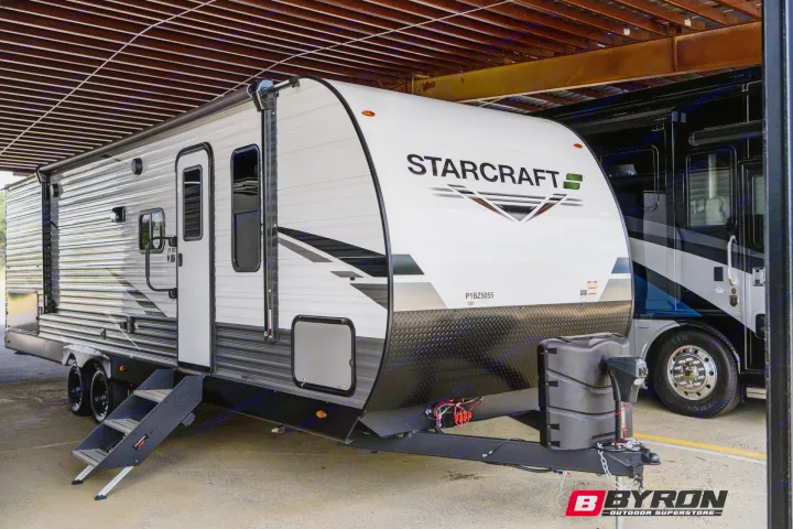 This white StarCraft travel trailer, an ideal RV rental, is ready for your outdoor adventures. Parked under cover.. Starcraft Autumn Ridge 2023
