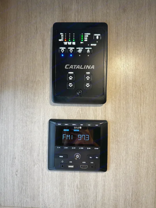 RV rental control panels: tank levels, battery, lights, awning, slide, and entertainment stereo system.. Coachmen Catalina 2022
