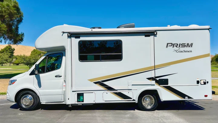 A white Coachmen Prism Class C RV, ready for an rv rental adventure, parked on a sunny day.. Coachmen Prism 2024