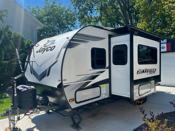 This Jayco Jay Feather Micro travel trailer, great for RV rental, with slide-out extended and bike rack mounted.. Jayco Jay Feather Micro 2022