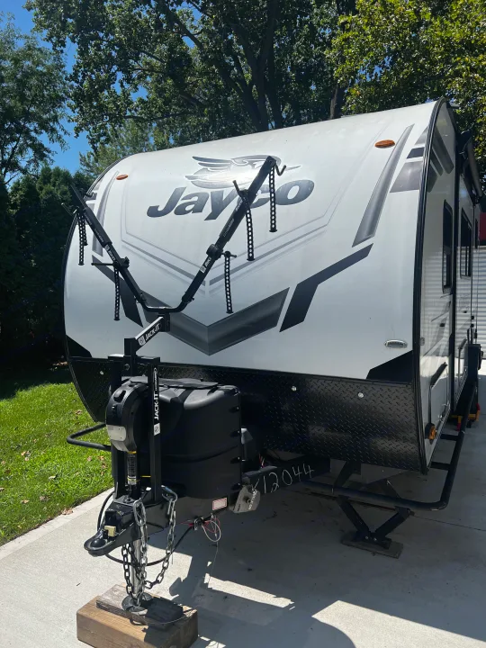White Jayco travel trailer with a Jack-It bike rack, perfect for an RV rental adventure.. Jayco Jay Feather Micro 2022