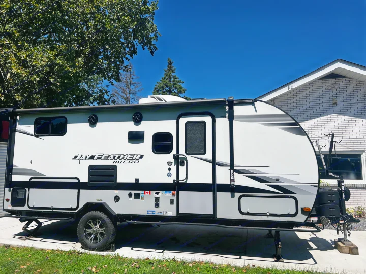 Jay Feather Micro travel trailer, a compact RV, parked on a driveway. Ready for rv rental adventures.. Jayco Jay Feather Micro 2022