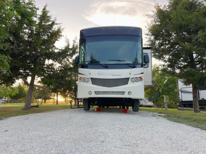 A beautiful white and black Georgetown RV rental set up at a peaceful gravel campsite at sunset.. Georgetown Georgetown Motorhome 2016