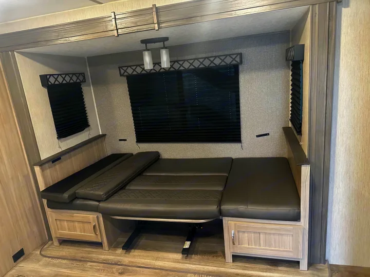 RV rental interior: convertible dinette seating that transforms into a cozy bed, ideal for compact travel living.. Coachmen fet257bhs-320 2021