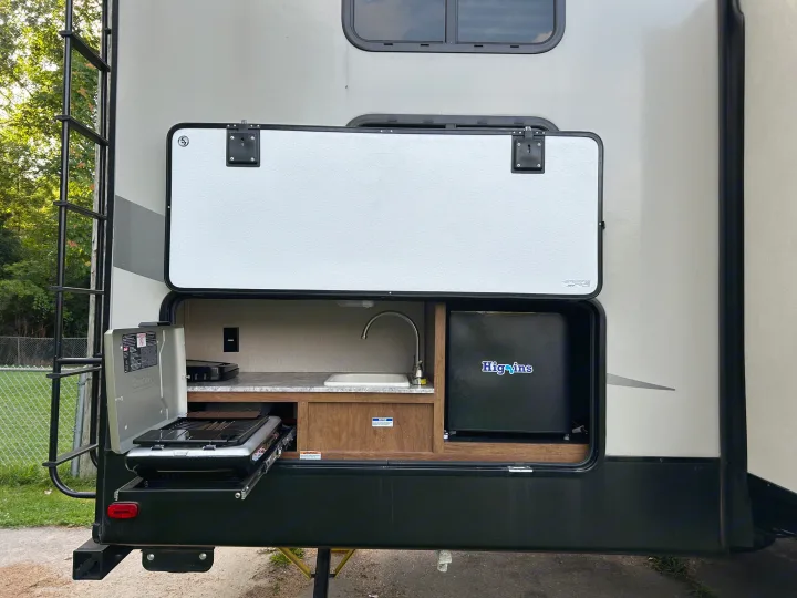 Enjoy camping with this RV rental's outdoor kitchen, including a pull-out grill, sink, and mini-fridge.. Forest River Coachmen Chaparral Lite 2019