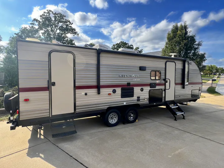 A spacious Grey Wolf travel trailer, perfect for your next rv rental adventure, is shown parked outdoors on a bright day.. Forest River Cherokee Grey Wolf 2019