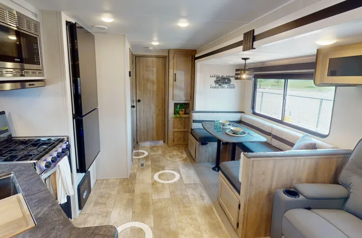 Spacious RV rental interior with a full kitchen, cozy dinette, and comfortable seating for your adventures.. Forest River Puma 2023