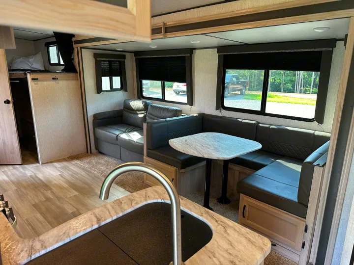 RV rental: Modern interior with living sofa, U-shaped dinette, kitchen sink, and bunk bed. Bright, spacious layout.. Coachmen 2021 Coachman Sprinter Campfire Edition 2021