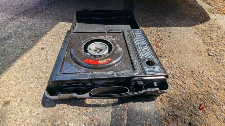 A black portable gas stove, ideal for outdoor cooking on an RV rental or camping adventure.. Dodge Grand Caravan 2014