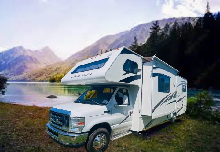 A white Chateau Class C RV rental, ready for adventure by a picturesque lake and mountains.. Four Winds Chateau 2011