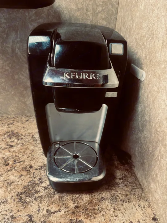 A black Keurig coffee maker sits on a speckled countertop, a convenient amenity in this RV rental unit.. Four Winds Chateau 2011