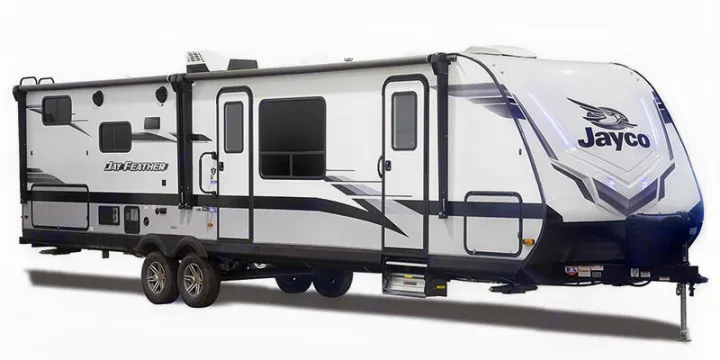 Side view of a modern white and black Jayco Jay Feather travel trailer RV for rv rental. Features multiple windows, doors, and awning.. Jayco JAY FEATHER 26RB 2021