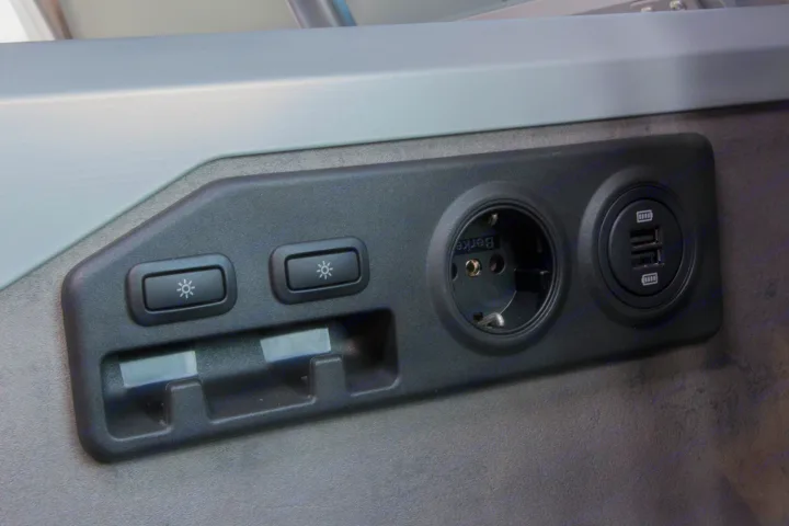 RV rental interior with European power outlet, dual USB ports, & reading light controls for convenience.. Volkswagen California Ocean 2025