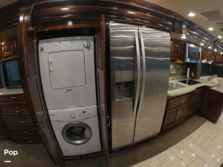 Luxury RV rental with full kitchen, stainless steel fridge, & stacked laundry. Compact living at its best.. American Coach Revolution 2017