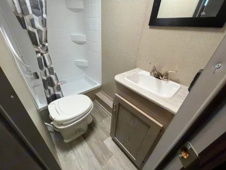 RV rental bathroom with compact shower, toilet, and sink setup for convenient travels.. Coachmen Catalina 2022