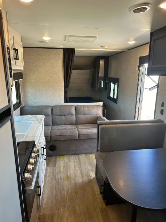 Spacious RV rental interior with kitchen, sofa, dinette, and bunk beds, perfect for family adventures.. Jayco Jay Flight 2022