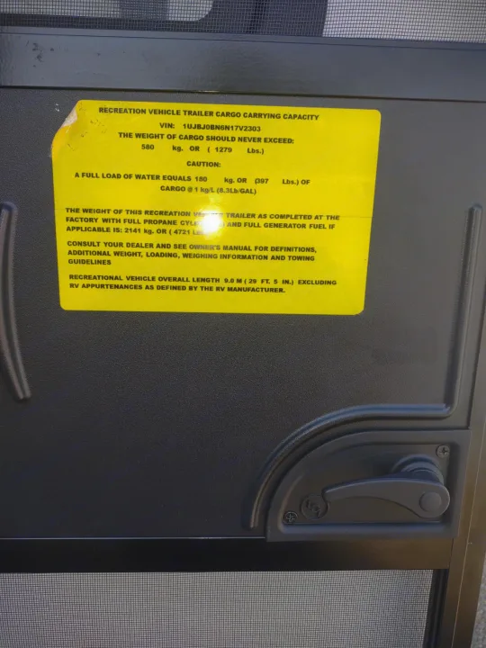 RV rental specs: yellow label on a door details cargo capacity, weights, and overall length for safe operation.. Jayco Jay Flight 2022