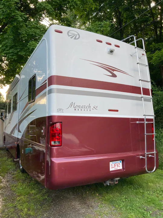 White & maroon Monaco Monarch SE RV, rear view with ladder. Ideal for your next RV rental adventure.. Monaco Monarch SE 2006