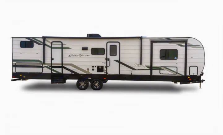 White Eddie Bauer travel trailer, an ideal RV rental with green/grey mountain graphics, perfect for camping.. Heartland RVs Eddie Bauer BHS 34 2024