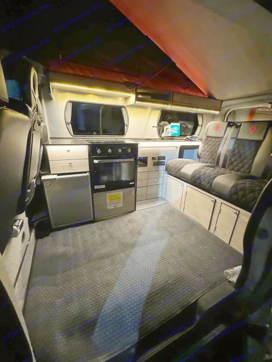 Experience an RV rental! This camper van features a sleek kitchen with oven, fridge, plush quilted seating, & warm LED lighting.. Renault Other 2023