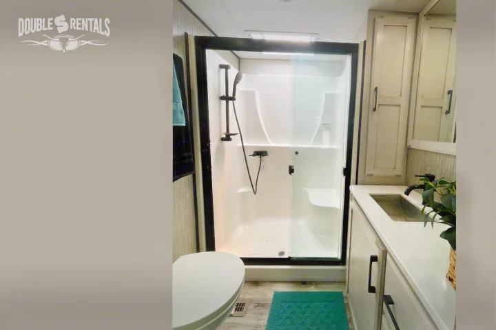Step into comfort: modern RV rental bathroom featuring a sleek shower, vanity with sink, and toilet for your next adventure.. KZ Durango Gold 2022