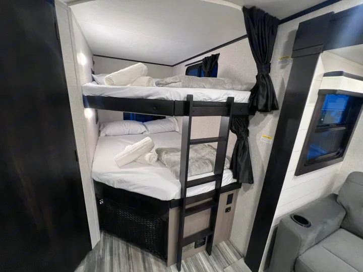 This RV rental offers comfortable bunk beds, complete with fresh linens and individual lighting, plus a cozy seating area.. Jayco Jay Feather 2024