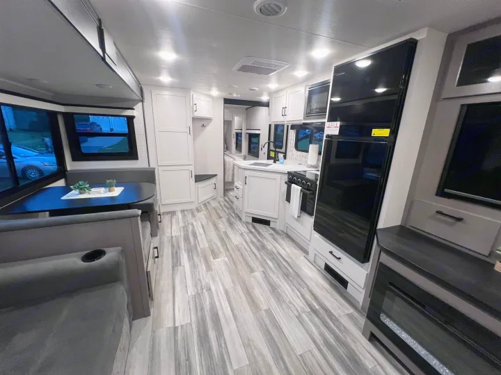 Step inside this modern RV rental! Features a bright kitchen, dining area, and cozy living space with fireplace.. Jayco Jay Feather 2024