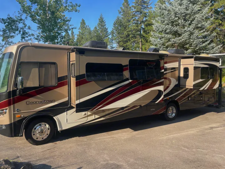 Georgetown RV rental: a large motorhome with extended slide-outs, parked outdoors.. Georgetown GT5 2019