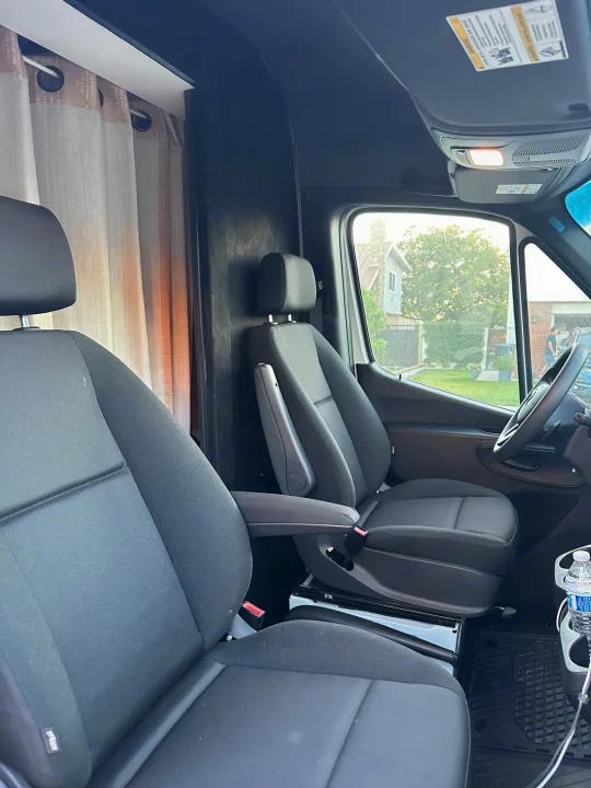 RV rental van interior: comfortable cabin with swivel front seats, privacy curtains, and amenities.. Mercedes-Benz Sprinter 2022