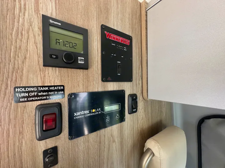 RV rental control panel: Truma, Winnebago tank, and Xantrex solar systems. Manage heat, water, and power.. Winnebago Solis 2025
