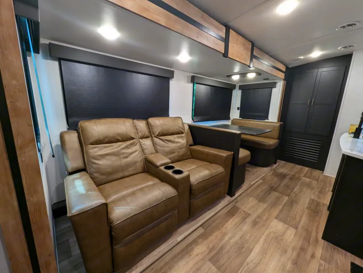 Experience comfort in this RV rental featuring cozy recliners, a spacious dinette, and modern interiors. Your perfect travel trailer home.. Keystone RV Outback 2022