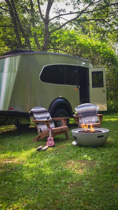 Experience outdoor living with this RV rental. Relax by the fire pit, surrounded by nature, with comfy chairs and a ukulele.. Airstream Base Camp 2023