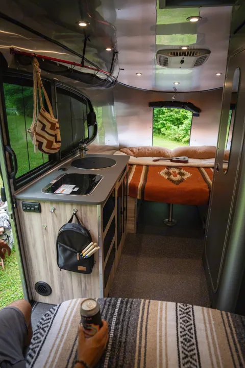 Step inside this cozy RV rental! Features a compact kitchenette, comfy bed with ukulele, and smart storage.. Airstream Base Camp 2023