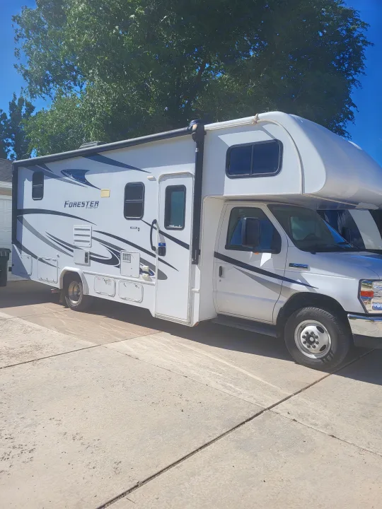 Bright white Forester Class C rv rental, with grey graphics, parked on a sunny driveway. Ready for adventure!. Forester Forester Motorhome 2020