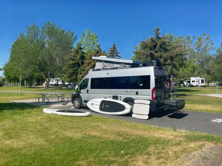 This Thor Tellaro RV rental is perfectly set up at a campground. Paddleboards and bikes are ready for water and trail adventures.. Thor Tellaro 2022