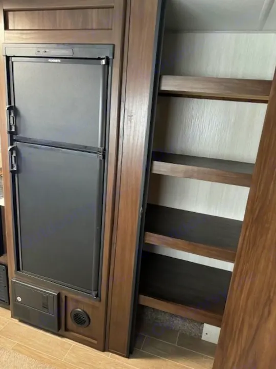 RV rental interior: Dometic fridge & pantry with four shelves. Essential storage for your adventures.. Forest River Cherokee Grey Wolf 2020