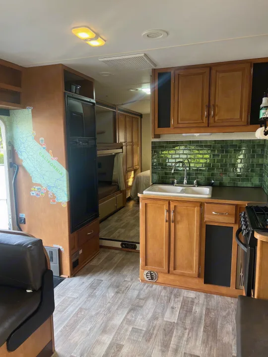 This RV rental boasts a well-equipped kitchen with a green subway tile backsplash & built-in bunk beds.. Winnebago Minnie Winnie 2017