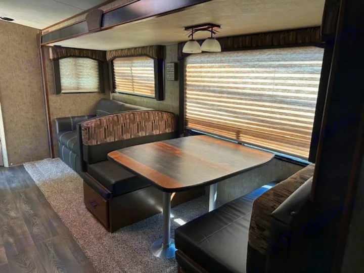 Spacious RV rental interior featuring a dinette, sofa, and compact living area, perfect for comfortable travel adventures.. Outdoors RV Timber Ridge 2020