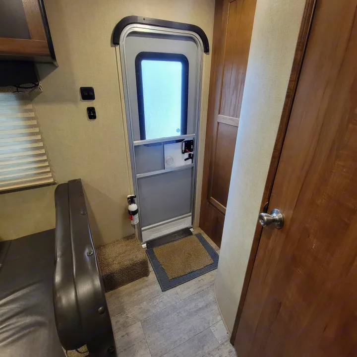 RV rental interior: View of the entrance door, screen, fire extinguisher, control panel, and part of the living space.. Gulf Stream Ameri-Lite 2018