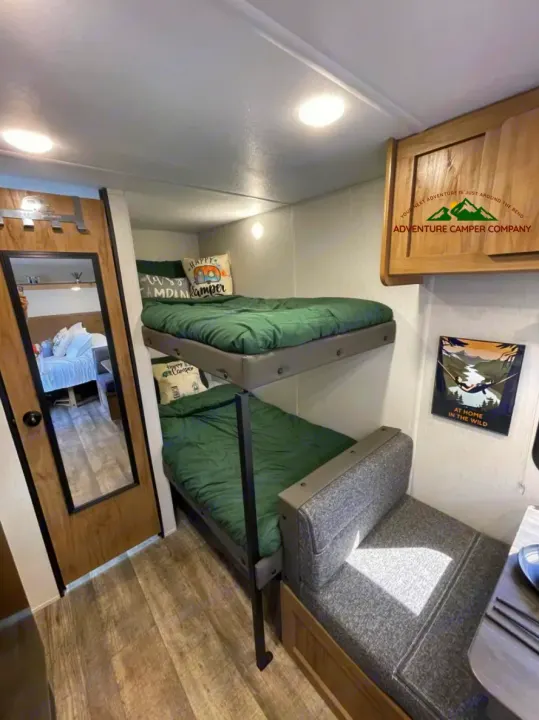 This RV rental offers a compact yet comfortable interior with built-in bunk beds and a dinette. Ready for your next camper adventure!. Forest River Cherokee Wolf Pup 2024