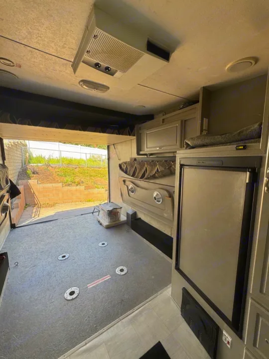 Inside an RV rental toy hauler with its large rear cargo area for gear.. Weekend Warrior 1800sxfk 2009